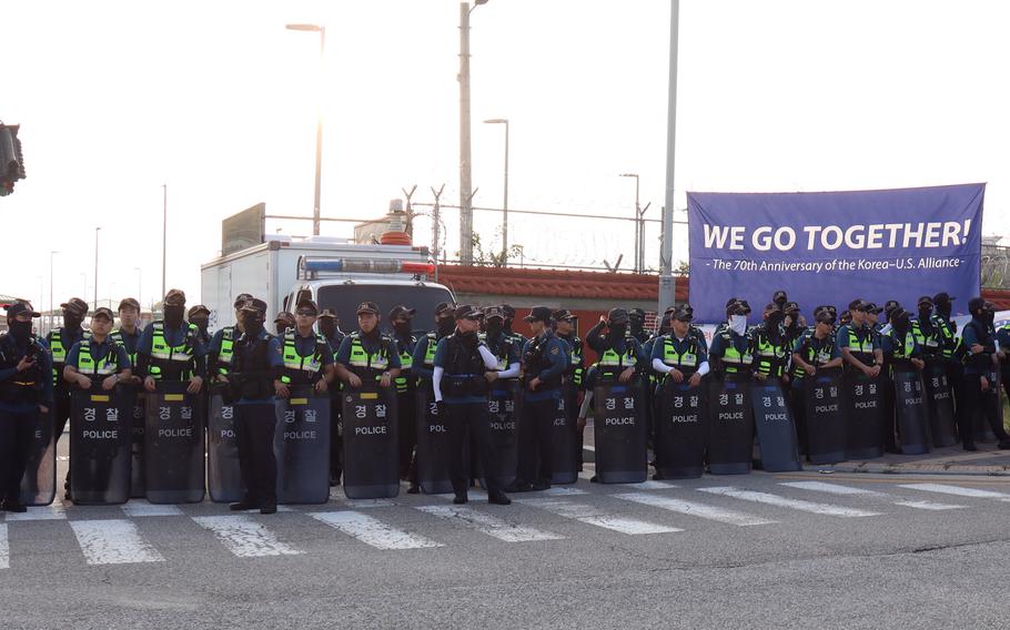 South Korean police form a line to keep protesters from entering the main gate at Camp Humphreys, South Korea, Thursday, July 27, 2023. 