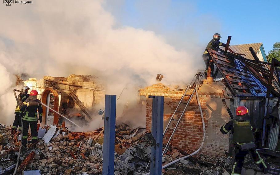 Rescuers work at a damaged building after a Russian missile attack in Kyiv region, Ukraine, Wednesday, May 8, 2024. 