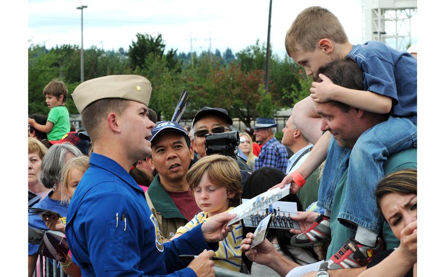 Then-Lt. Cmdr. Frank Weisser, who was the lead solo pilot of the Blue Angels, signs autographs during Navy Week at the Seattle Seafair in 2010. 
