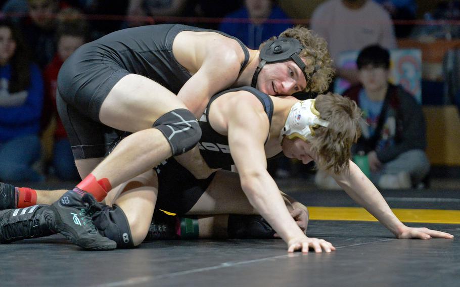 William Pierce of Brussels, top, beat Joel Workman of Hohenfels to take the 175-pound title at the DODEA-Europe wrestling championships, in Wiesbaden, Germany, Feb. 11, 2023. 