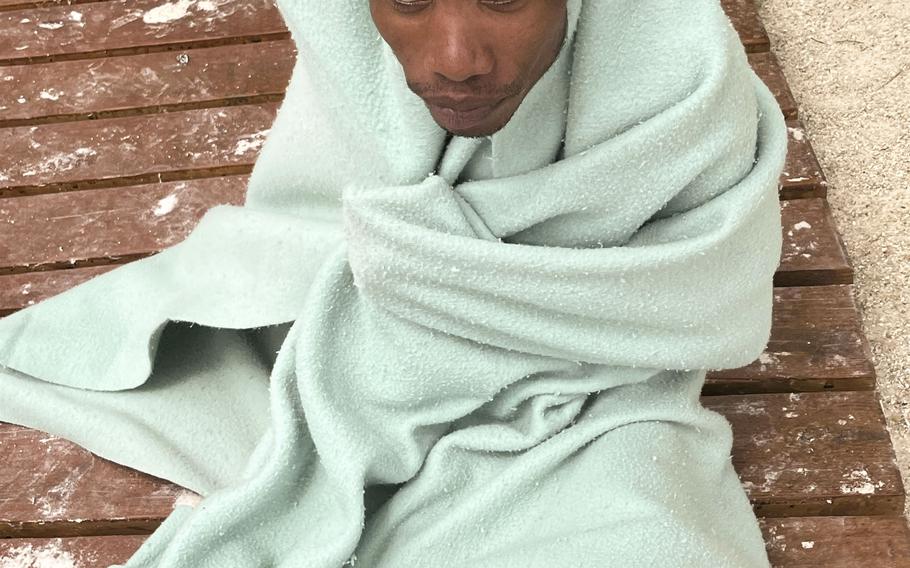 A Haitian migrant rests with a blanket after making it to shore in Summerland Key. 