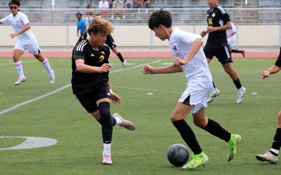 Kadena's Ethan Romney defends againsts OCSI's Jonathan Blackston.
