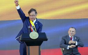 President Gustavo Petro raises his fist at the end of his inauguration speech in Bogota, Colombia, Sunday, Aug. 7, 2022. 