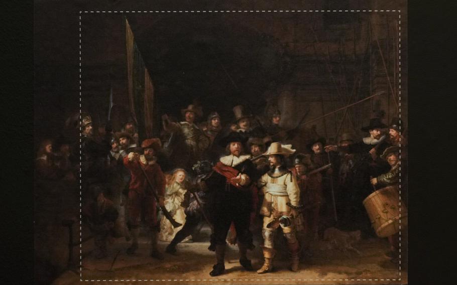 A photograph with lines showing the added parts explains how Rembrandt's biggest painting the Night Watch just got bigger with the help of artificial intelligence in Amsterdam, Netherlands, Wednesday, June 23, 2021. The Dutch national museum and art gallery reveals findings from a long-term project to examine in minute detail Rembrandt van Rijn's masterpiece the Night Watch.