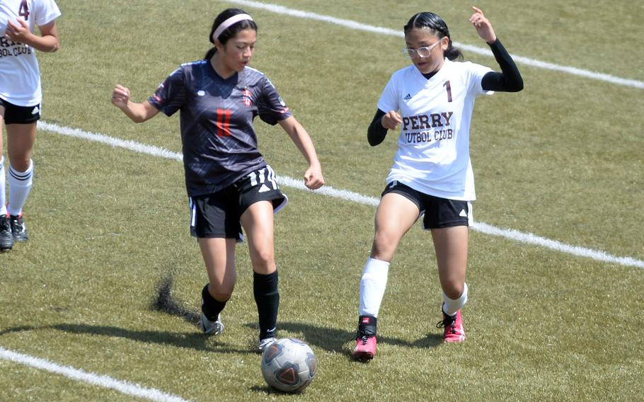 Nile C. Kinnick's Valentina Sacca and Matthew C. Perry's Elieza Cuaco scuffle for the ball during Saturday's DODEA-Japan girls soccer match. The Red Devils won 2-0.