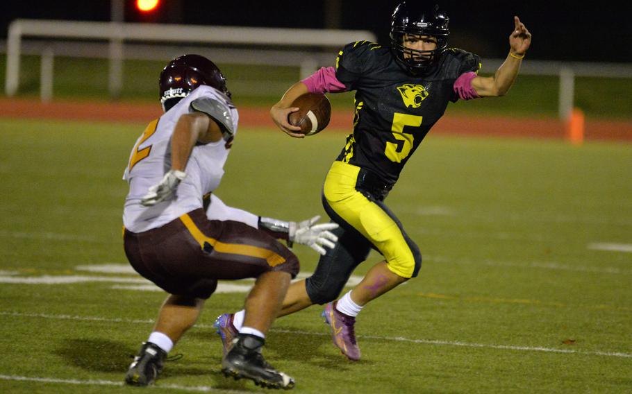 Stuttgart’s Itzak Sandoval tries to get past Vilseck’s Justin Barnes in the DODEA-Europe Division I football championship game at Kaiserslautern, Germany, Oct. 29, 2022. Stuttgart took the title with a 51-12 win.