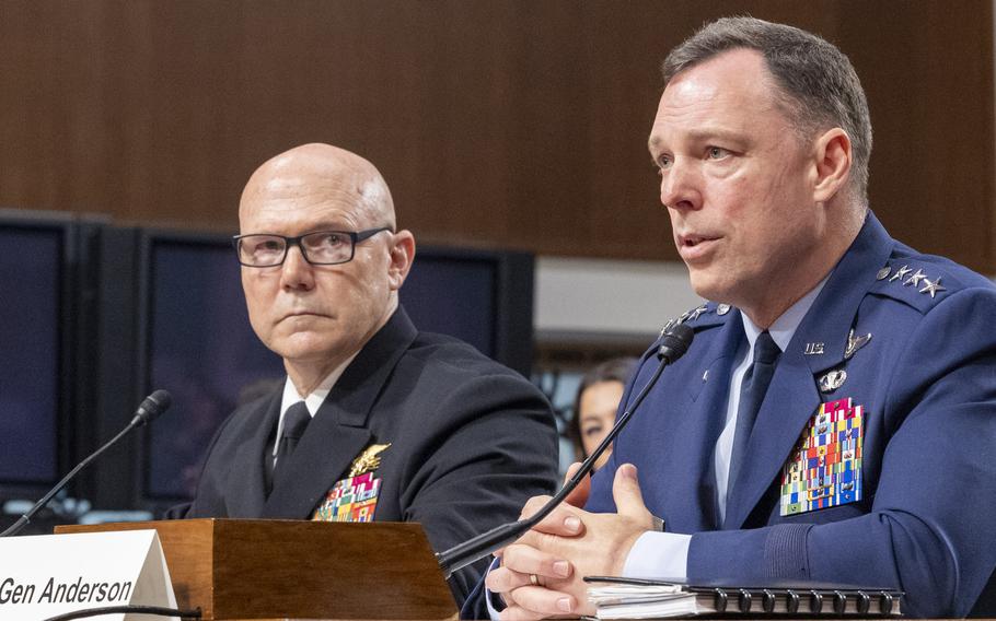 Vice Adm. Frank Bradley, left, and Lt. Gen. Dagvin Anderson are in uniform and seated. Bradley is looking at Anderson as he speaks.