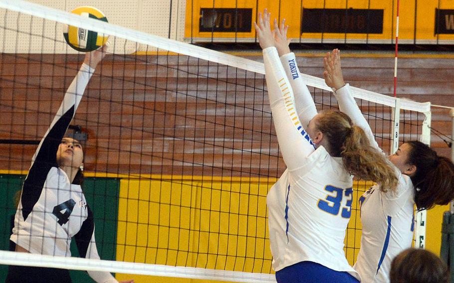 Zama's Emma Sakamoto-Flack attempts a spike against Yokota's Devynn Martin and Malia Hutchins during Saturday's Japan girls volleyball match. The Panthers won in four sets.