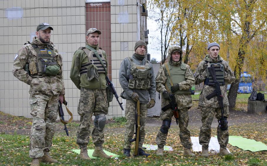 Ukrainian soldiers gather to practice combat first aid at a training site on the outskirts of Kyiv, on Oct. 27, 2022.