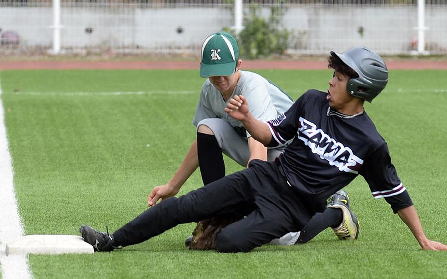 Zama's Hiroki Davis slides in safely ahead of the tag by Kubasaki third baseman Brayden Milam during Friday's inter-division, inter-district baseball game. The Dragons beat the Trojans 6-4.