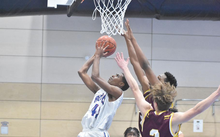 Ramstein’s Bryson Bishop eludes the Vilseck defense to score a basket on Thursday, Feb. 24, 2022, at the DODEA-Europe basketball finals.