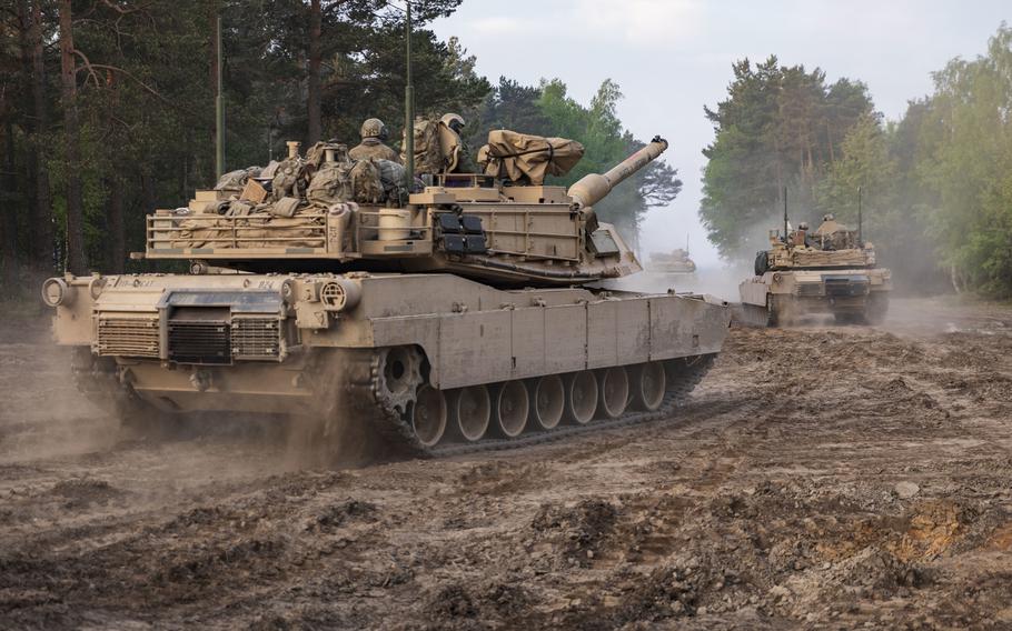 Soldiers on M1A2 Abrams tanks from the 1st Armored Brigade Combat Team, 1st Infantry Division move out in an exercise at Johanna Range, Poland, in 2019. Poland would likely be considered if the Pentagon decides to bring a tank unit back to Europe.
