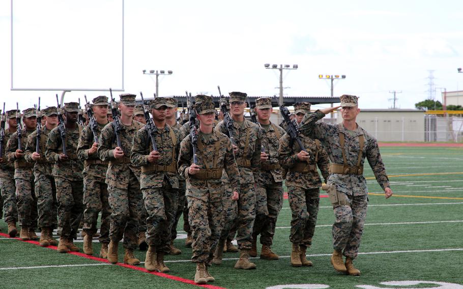 Members of the newly minted 12th Marine Littoral Regiment march at the conclusion of a redesignation ceremony for the unit at Camp Hansen, Okinawa, Wednesday, Nov. 15, 2023.