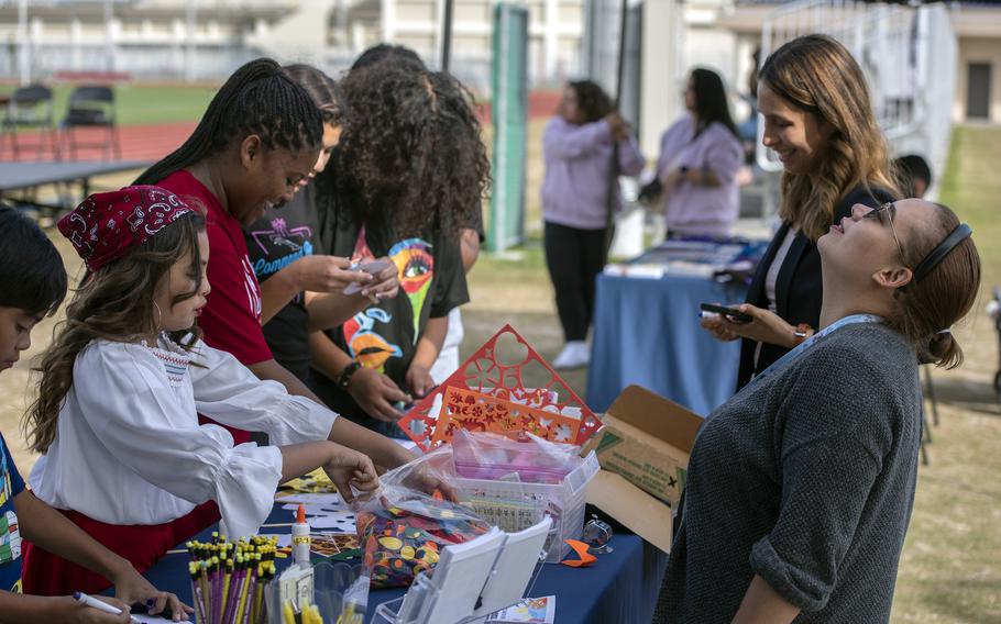 People decorate a Dia De Los Muertos mask during the Hispanic Heritage Month celebration at Marine Corps Air Station Iwakuni, Japan, Oct. 13, 2023.