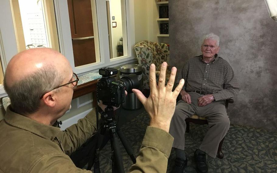 Jeffrey Rease takes a picture of World War II veteran Russell Brakefield in 2020. Brakefield, 93, died on July 2, 2021. 