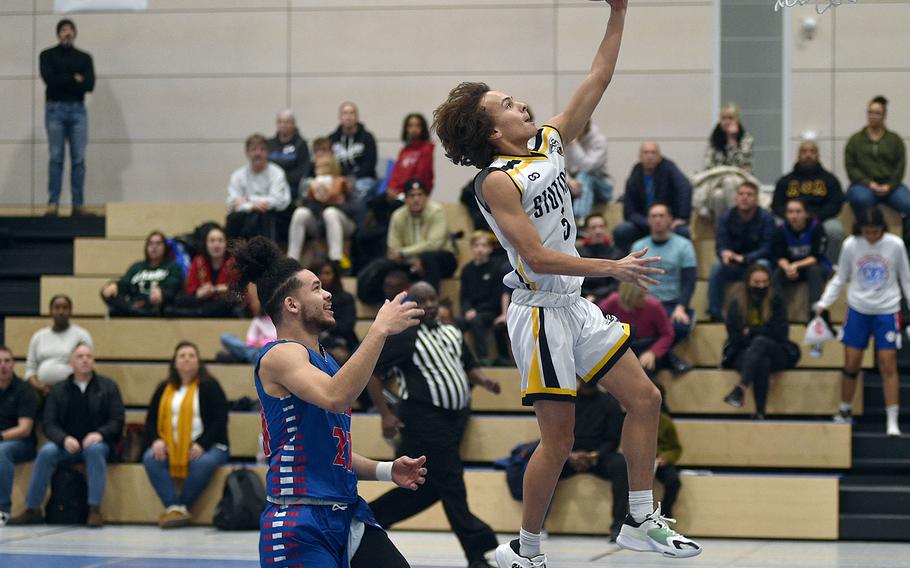 Stuttgart's Ryan Stevenson goes for a layup while Ramstein's Israel Rouse trails during a game at Ramstein High School on Saturday afternoon on Ramstein Air Base, Germany. The Panthers won, 55-43.