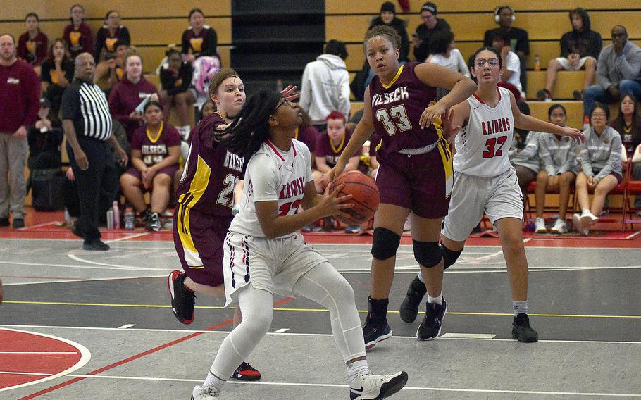 Kaiserslautern's Gabby Myrick picks up the ball as she's about to go up for a layup  during a Dec. 2, 2023, game against at Kaiserslautern High School in Kaiserslautern, Germany