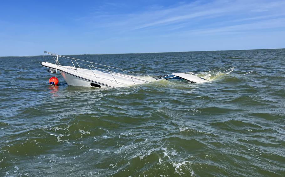 Two people were rescued Saturday from a 47-foot boat that struck a submerged object and sank in the Delaware Bay, according to the Coast Guard.