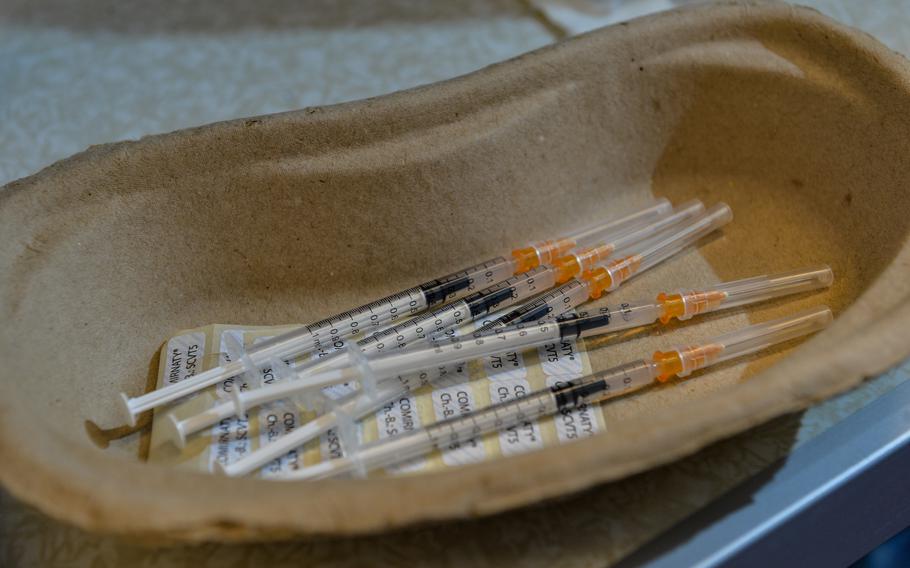 Needles containing the Pfizer/BioNTech COVID-19 booster vaccine lay prepared for delivery to patients during a vaccination bus event in Kaiserslautern, Germany, Nov. 30, 2021. German Red Cross officials expected more than 500 vaccine recipients during the event at Kaiserslautern Technical University. 