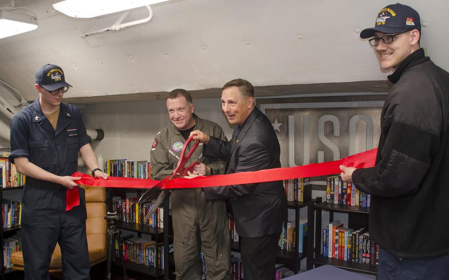 The USS Ronald Reagan's skipper, Capt. Daryle Cardone, and USO Regional Vice President Scott Maskery cut a ribbon to open a USO center aboard the aircraft carrier at Yokosuka Naval Base, Japan, April 17, 2024.