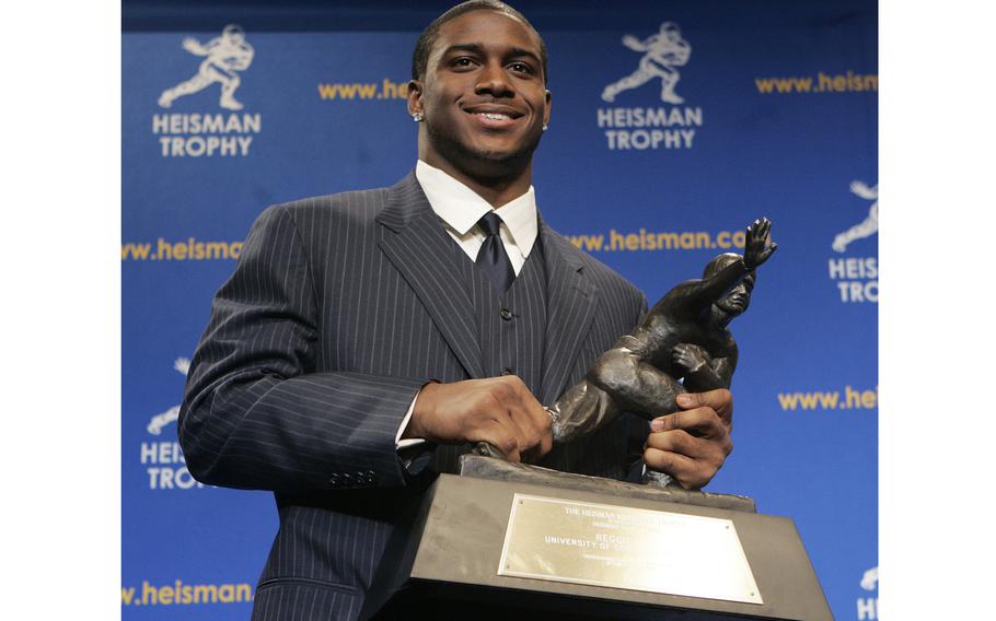 Heisman Trophy winner Reggie Bush of the University of Southern California poses for photos after a news conference in New York, Dec. 10, 2005. Bush has been reinstated as the 2005 Heisman Trophy winner.
