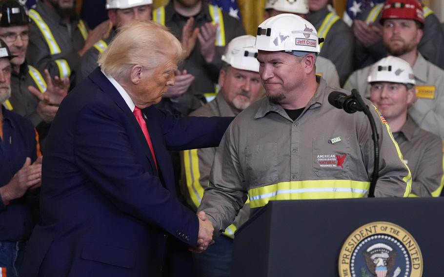 President Trump shaking hands with a coal miner.