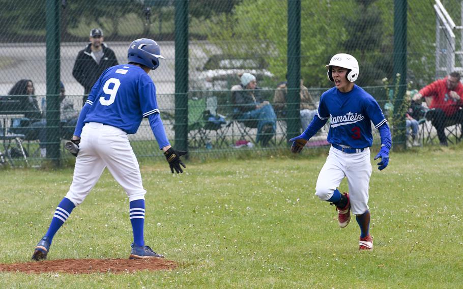 Ramstein's Keegan Cornelius celebrates with teammate Liam Delp after a wild rush to home base during a 16-3 victory over Kaiserslautern on Saturday, April 30, 2022, in Kaiserslautern, Germany.