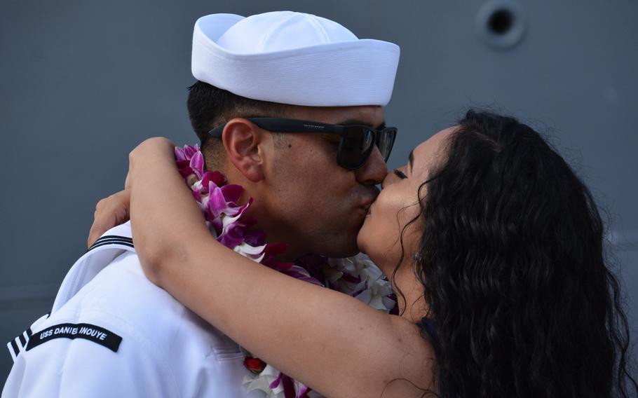 Tech 1st Class Israel Ramos indulges in the ceremonial "first kiss" with his wife, Anahi, prior to the rest of the crew of the Daniel Inouye debarking the ship at Joint Base Pearl Harbor-Hickam, Hawaii, Thursday, Nov. 18, 2021.