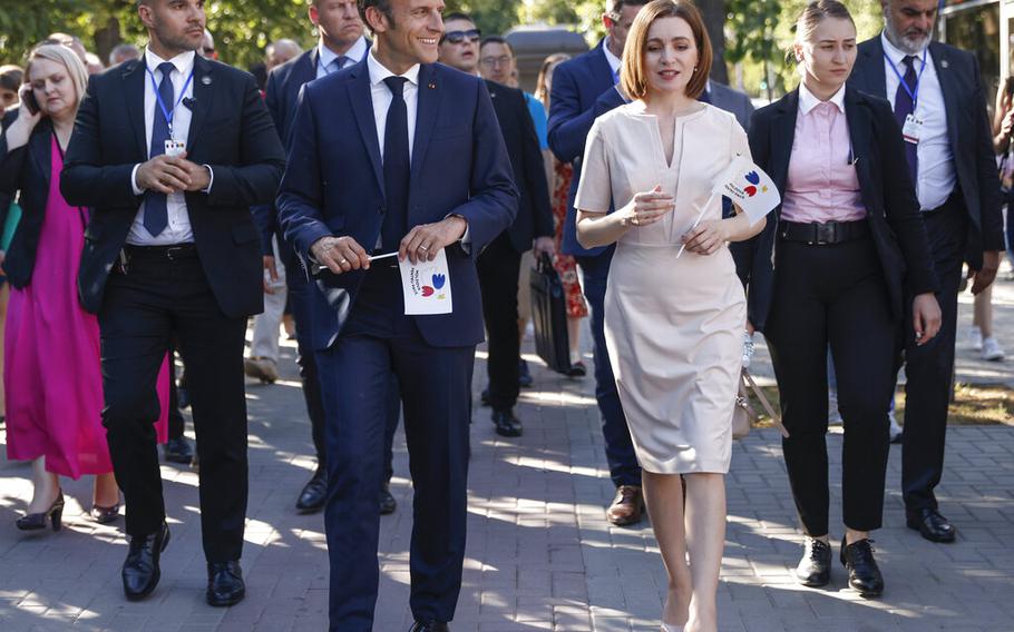 France’s President Emmanuel Macron and Moldova’s President Maia Sandu walk in Chisinau, Moldova, on June 15, 2022. EU leaders on Thursday, June 23, granted Moldova candidate status to be considered as a possible bloc member.