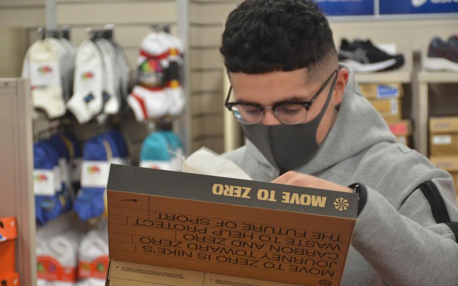 An exchange shopper wears a mandatory mask while checking out footwear at Yokosuka Naval Base, Japan, Friday, Jan. 7, 2022.