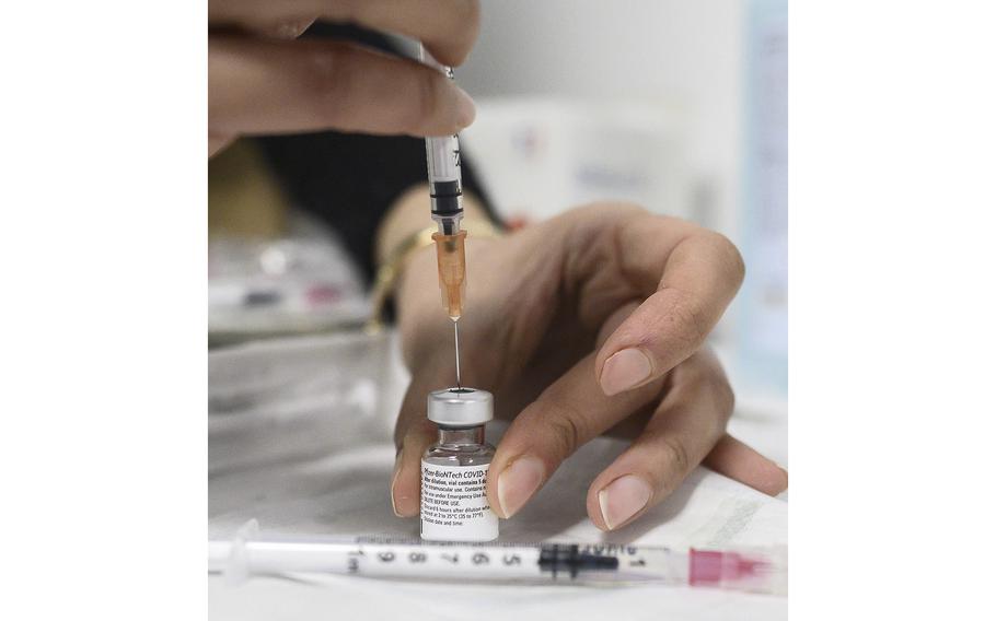 A health worker prepares a syringe with the Pfizer/BioNTech Covid-19 vaccine on Jan. 6, 2021, in Aulnay-sous-Bois, France. 