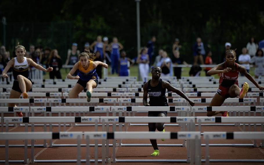 From right, Lellah Guhn of Kaiserslautern leaps over a hurdle to win the girls 100 meter hurdles at the 2024 DODEA European Championships at Kaiserslautern High School in Kaiserslautern, Germany, on May 24, 2024.