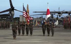 Marines stand at attention on Marine Corps Air Station Futenma, Okinawa, as Maj. Gen. Eric Austin takes command of the 1st Marine Aircraft Wing from Maj. Gen. Brian Cavanaugh, Friday, Aug. 12, 2022. 
