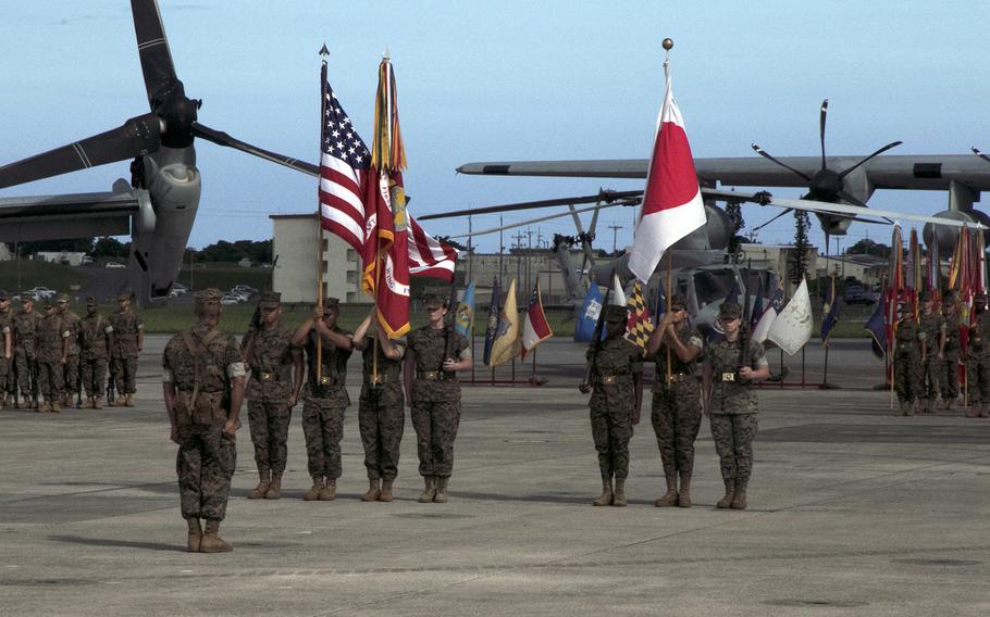 Marines stand at attention on Marine Corps Air Station Futenma, Okinawa, as Maj. Gen. Eric Austin takes command of the 1st Marine Aircraft Wing from Maj. Gen. Brian Cavanaugh, Friday, Aug. 12, 2022. 