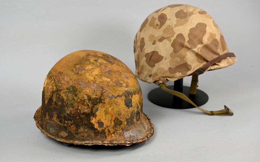 A helmet used during the battle for Tarawa in 1943 is paired with an unused version at the National Museum of the Marine Corps. 