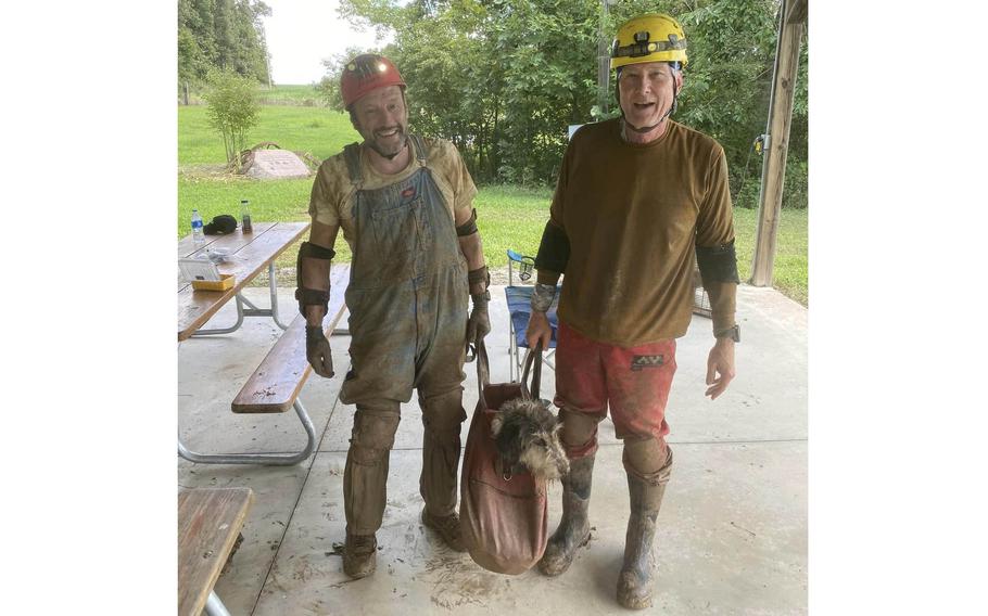 Gerry Keene, left, and Rick Haley with Abby after they rescued her from a Missouri cave Aug. 6, 2022. 