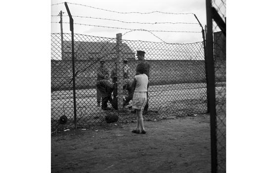 Berlin, West Germany, Sept. 15, 1961: A West Berlin girl looks on as young, uniformed East Germans roll out barbed wire. 

Read the banter between the East and West Berliners as the barriers that would later become the Berlin Wall were erected here.

META TAGS: Berlin Wall; Cold War; barbed wire; border; communism; East Berlin; West Berlin; East Germany; West Berlin; children; border guards
