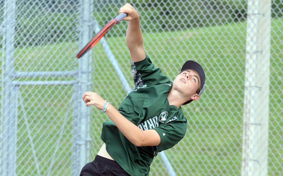Kubasaki's Jacy Fisk serves during Tuesday's Okinawa's doubles tennis matches. Fisk teamed with Owen Ruksc to win his boys doubles match, then with Lan Legros to win his mixed doubles match.