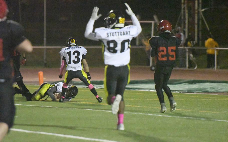 Stuttgart's Ian Lewis, right, and Jackson Houseworth, center, celebrate as teammate Marcell Mailey scores a touchdown in the Panthers' 53-12 victory over Kaiserslautern at Kaiserslautern, Friday, Oct. 15, 2021. 