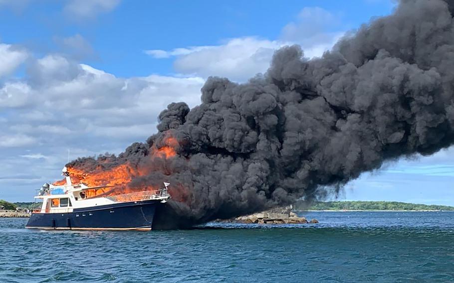 This image provided by New Hampshire State Police shows a yacht burning on the Piscataqua River in New Castle, N.H., Saturday, June 18, 2022.