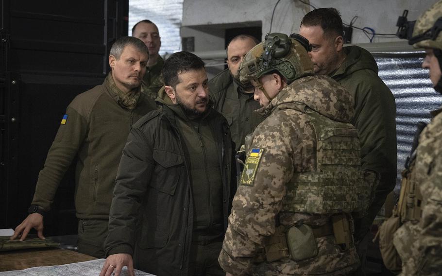 Ukraine President Volodymyr Zelenskyy talks to the commander of ground forces, Col. Gen. Oleksandr Syrsky, during a visit to the front-line city of Kupiansk, Kharkiv region, Ukraine, on Nov. 30, 2023. 