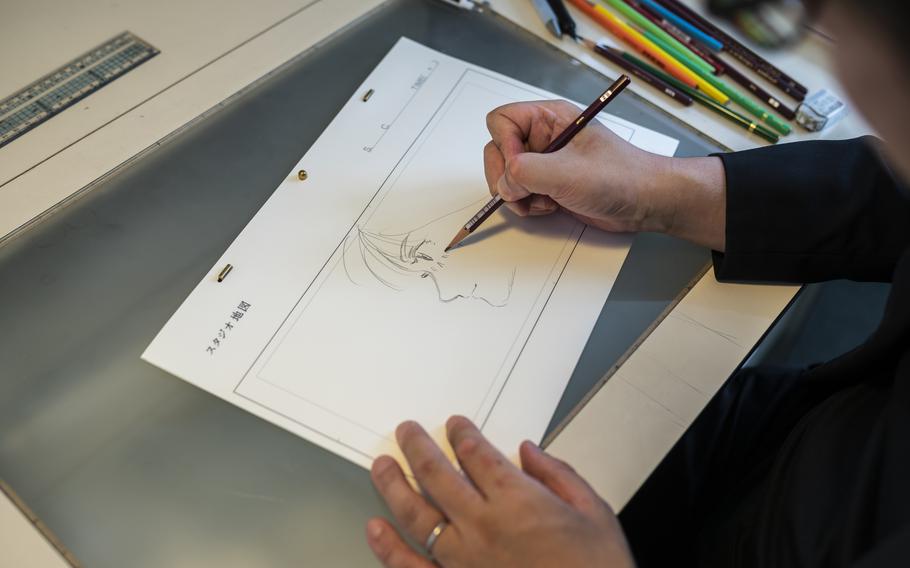 Mamoru Hosoda draws at his office in Studio Chizu in Tokyo on Sept. 9. 