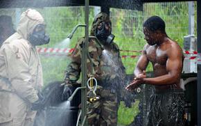 A U.S. Marine, left, who specializes in chemical, biological, radiological and nuclear defense, leads decontamination training during the Cobra Gold exercise in Rayong, Thailand, on March 3, 2024. 
