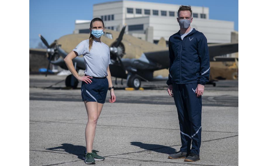 Air Force Uniform Office members 1st Lt. Avery Thomson and 2nd Lt. Maverick Wilhite put the updated versions of the Air Force physical training uniform through their paces at Wright-Patterson Air Force Base, Ohio, Feb. 25, 2021.  Airmen are now allowed to wear their PT shirts tucked or untucked and accompanied by sweatbands.