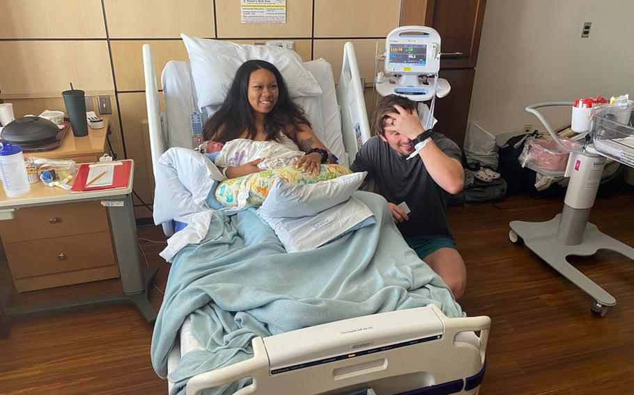 Air Force Master Sgt. Chelsey Barnes and her husband, Tech. Sgt. Sydney Barnes, pose with their newborn son at Brooke Army Medical Center, Fort Sam Houston, Texas, Jan. 1, 2023.