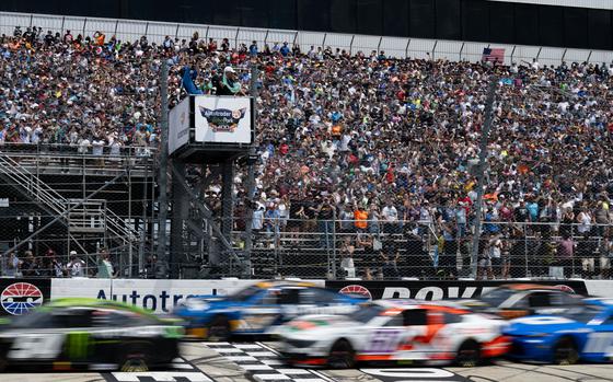 A race official waves the green flag signaling the start of the NASCAR Cup Series Autotrader EchoPark Automotive 400 race held at Dover Motor Speedway, July 20, 2025. Team Dover members participated in pre-race festivities which included presenting of the Colors by the Dover Air Force Base Honor Guard, the singing of the national anthem and a fly-over by a C-5M Super Galaxy. (U.S. Air Force photo by Airman 1st Class Liberty Matthews)