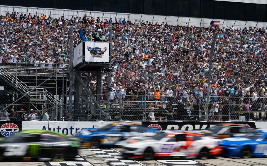Cars race on a track.