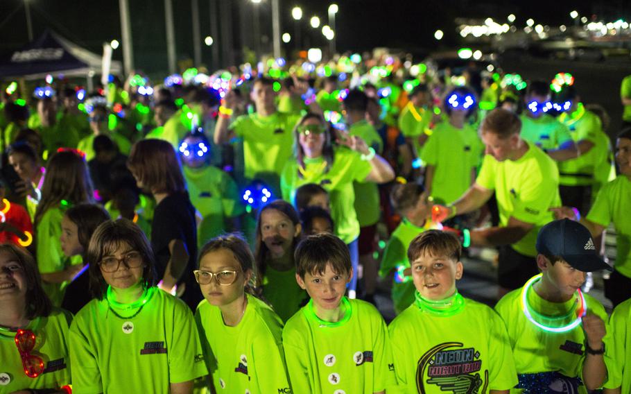 Glowing participants line up for a neon fun run at Atago Sports Complex in Iwakuni city, Japan, Saturday, June 24, 2023.