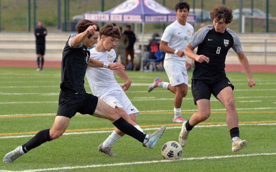 Ramstein’s Keiran Goodall gets a shot off between Stuttgart’s Christian Groves and Triston Milletich in the Royals’ 2-0 win over the Panthers in the Division I boys title game at the DODEA-Europe soccer championships in Ramstein, Germany, May 22, 2025. Ramstein took the title with a 2-0 win, with Goodall scoring the second goal..
