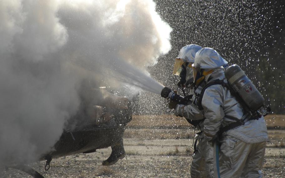 Firefighters extinguish a helicopter fire during a training exercise in 2007.  